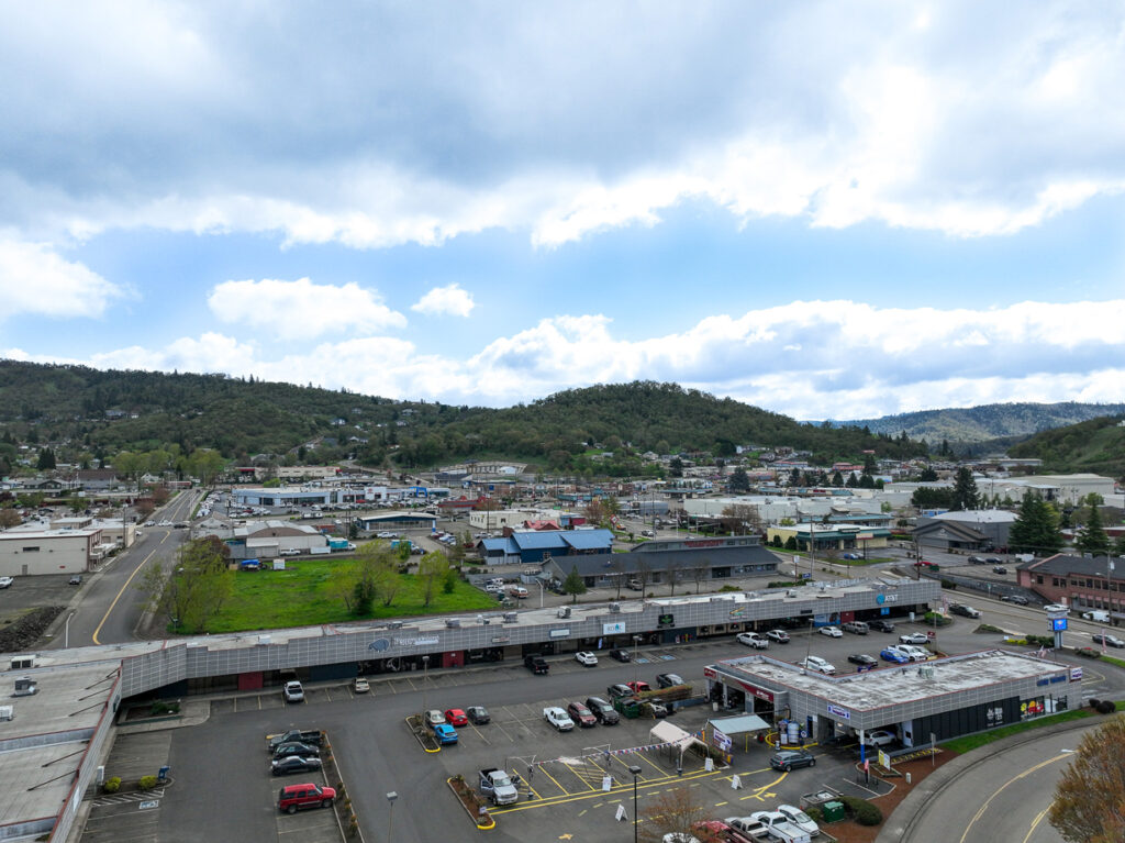 Revive_Infusions_and_Wellness-drone-garden-valley-blvd-roseburg-oregon Landscape drone image of Champion One Plaza and Garden Valley in Roseburg, Oregon, showing the location of Revive Infusions & Wellness, where patients receive root-cause treatments, IV therapy, peptide protocols, hormone optimization, and wellness care.