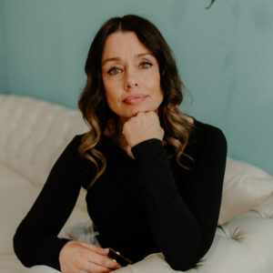 Medical Provider and PA-C, Founder Chenelle McCaskill, seated in the Hydration Lounge at Revive Infusions & Wellness in Roseburg, Oregon, prepared to welcome new patients for Functional Primary Care, Same Day Rapid Care, IV therapy, hormone optimization, and wellness treatments.
