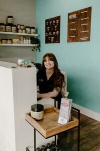 Medical Assistant Summar at the front desk of Revive Infusions & Wellness in Roseburg, Oregon, prepared to check in patients for IV therapy and IV nutrient wellness treatments.