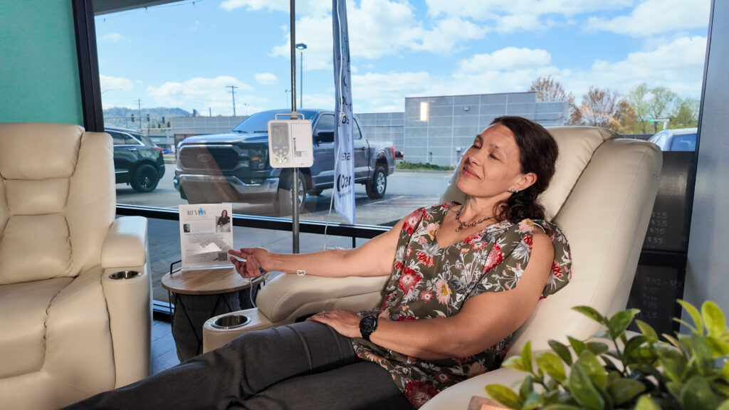 Patient comfortable, happy, and falling asleep, in the Revive Infusions and wellness hydration IV lounge. Patient comfortably relaxing and falling asleep during hydration IV therapy in the IV lounge at Revive Infusions & Wellness in Roseburg, Oregon.
